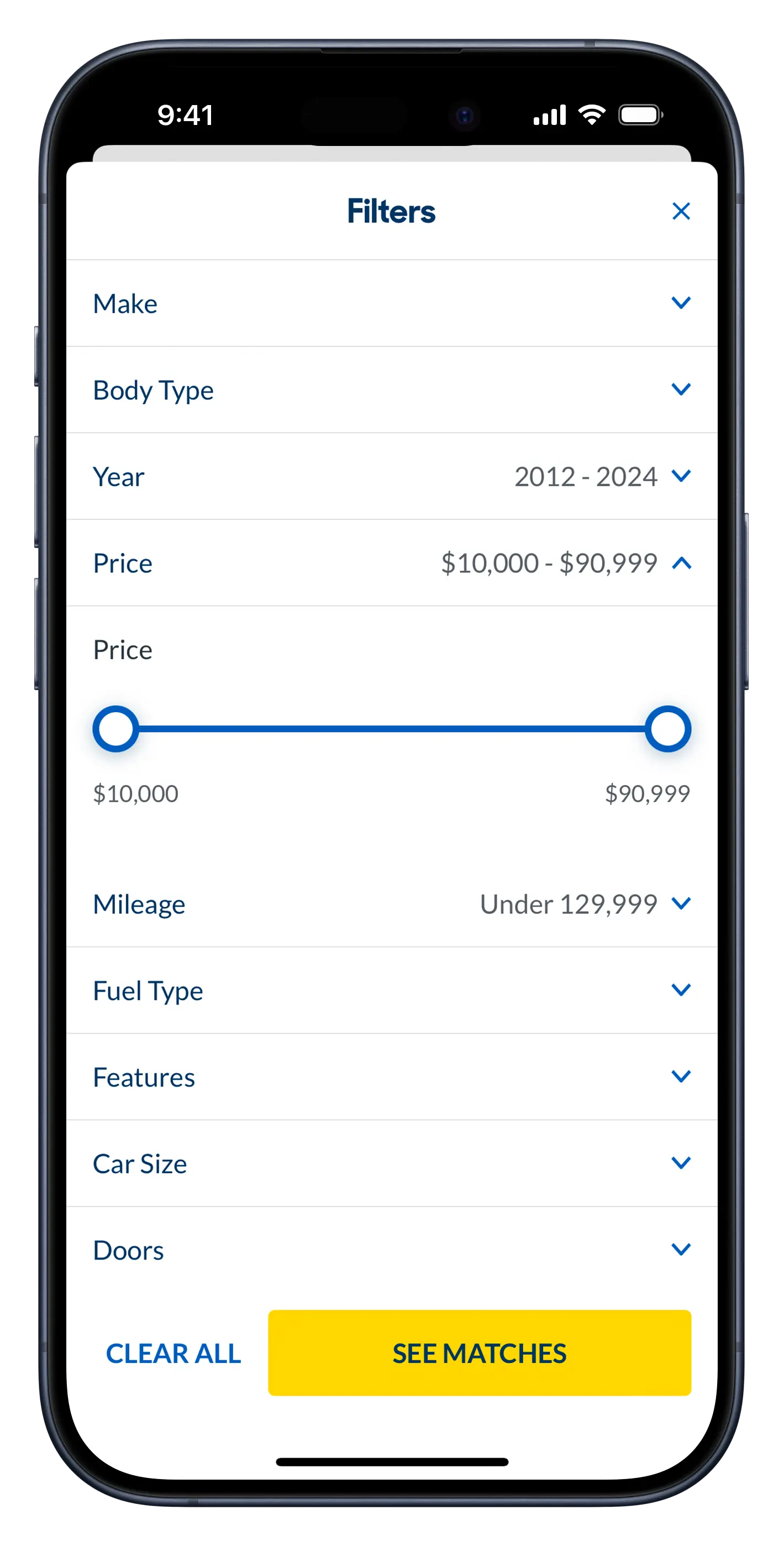 Screenshot of the CarMax app's 'Shop' filter screen, displaying a list of filters including 'make', 'body type', 'year', 'price' 'mileage', etc. A yellow action button appears at the bottom of the screen that reads 'See Matches'. To its left is a blue subdued button that reads 'Clear All'.